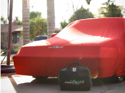 Red indoor car cover for 86-89 Acura Integra with bag, showcasing custom fit and snug design for vehicle protection.